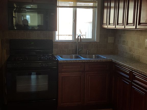 Updated Kitchen with granite counters and tile backsplash