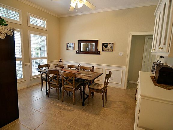 A very large formal dining room with great natural light and crown moulding.