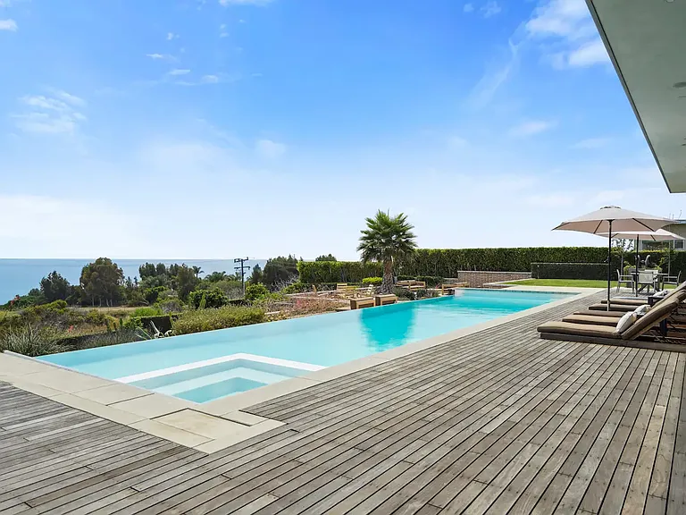 Expansive deck featuring chaise lounges and ample space for relaxation.