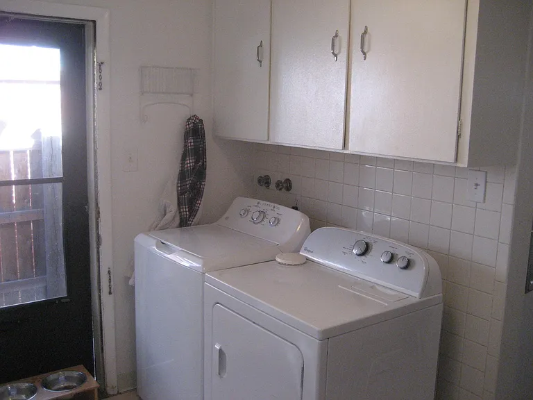 Washer/Dryer in unit with plenty of extra cabinet space