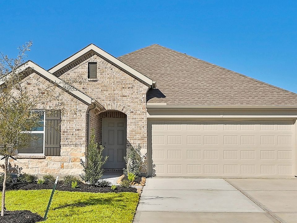 Exquisite brick facade and elegant gable roof define this River Ranch residence.