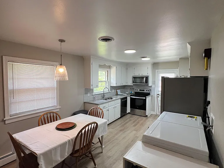 Eat-in kitchen with a dedicated dining nook, ample cabinetry, and a full appliance suite for everyday cooking.