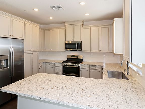 The kitchen as viewed from the dining area. Yes, those are quartz countertops.