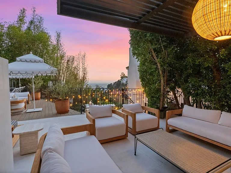 Lounge under soft light and watch the sky melt into color.