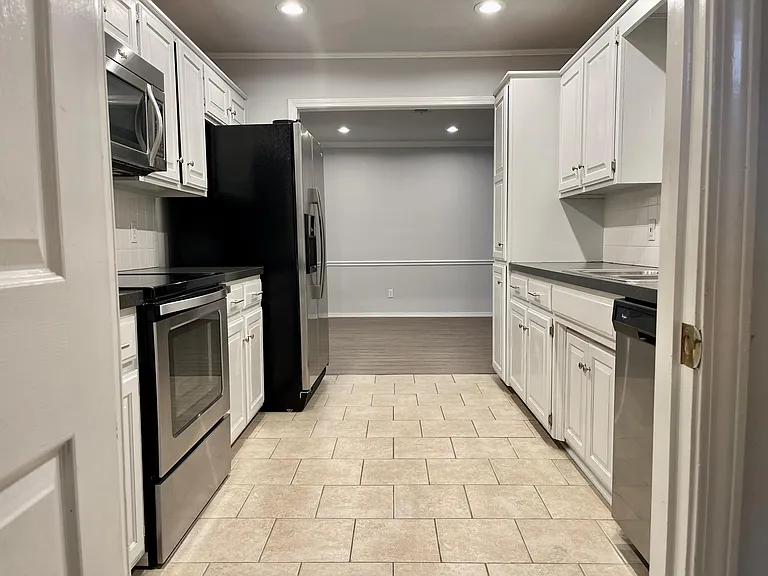 Newer Whirlpool Gold refrigerator w/ice and water in the door, smooth top range, microwave & dishwasher + pantry.