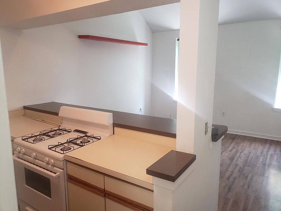 Galley kitchen with bar counter into living area