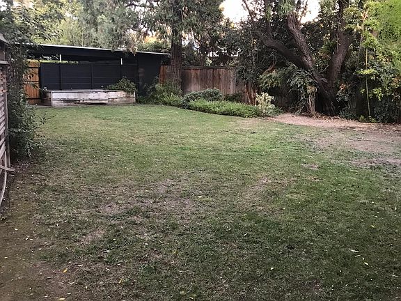 Large backyard with automatic sprinkler system.