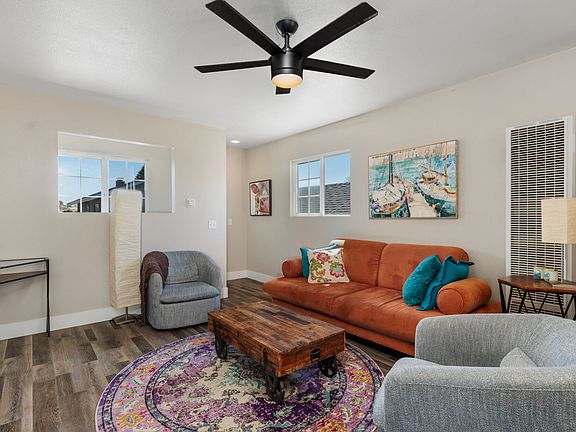 Living room with couch and swivel chairs.