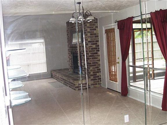  Family room looking out to covered & enclosed patio area.