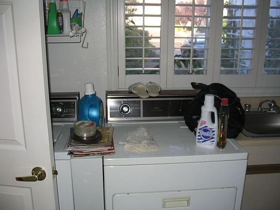 Laundry room with separate 3/4 bath off the garage with pool access