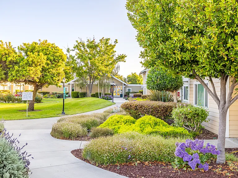 Charming landscaped walkways create a peaceful path through vibrant gardens.