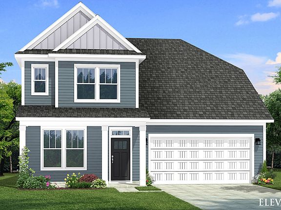 Two-story single family home with blue siding, a covered front porch and 2 car garage.
