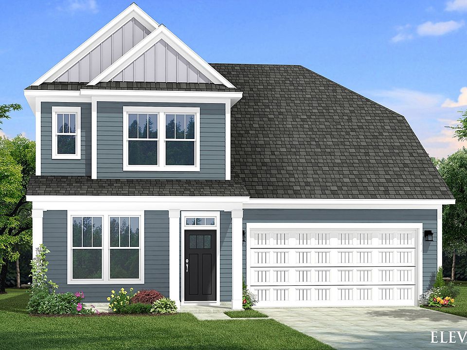 Two-story single family home with blue siding, a covered front porch and 2 car garage.