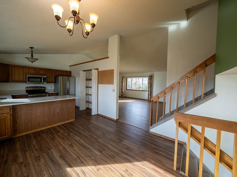 View from railing around dining area showing main floor layout and stairs to the upper level with bedrooms