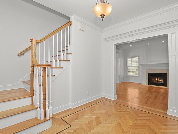 Entrance Foyer w/Views to Living Room w/Fireplace and Staircase to Second Level