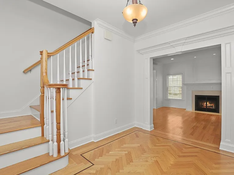 Entrance Foyer w/Views to Living Room w/Fireplace and Staircase to Second Level
