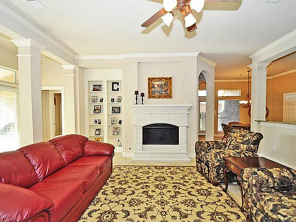 BUILT-IN BOOKSHELVES with STONE FIREPLACE IN FAMILY ROOM