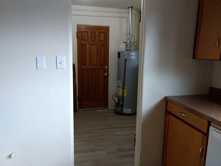 Utility room. Home for gas water heater, gas furnance, washer & dryer hookups. 
Space to add shelves or a small mudroom area.