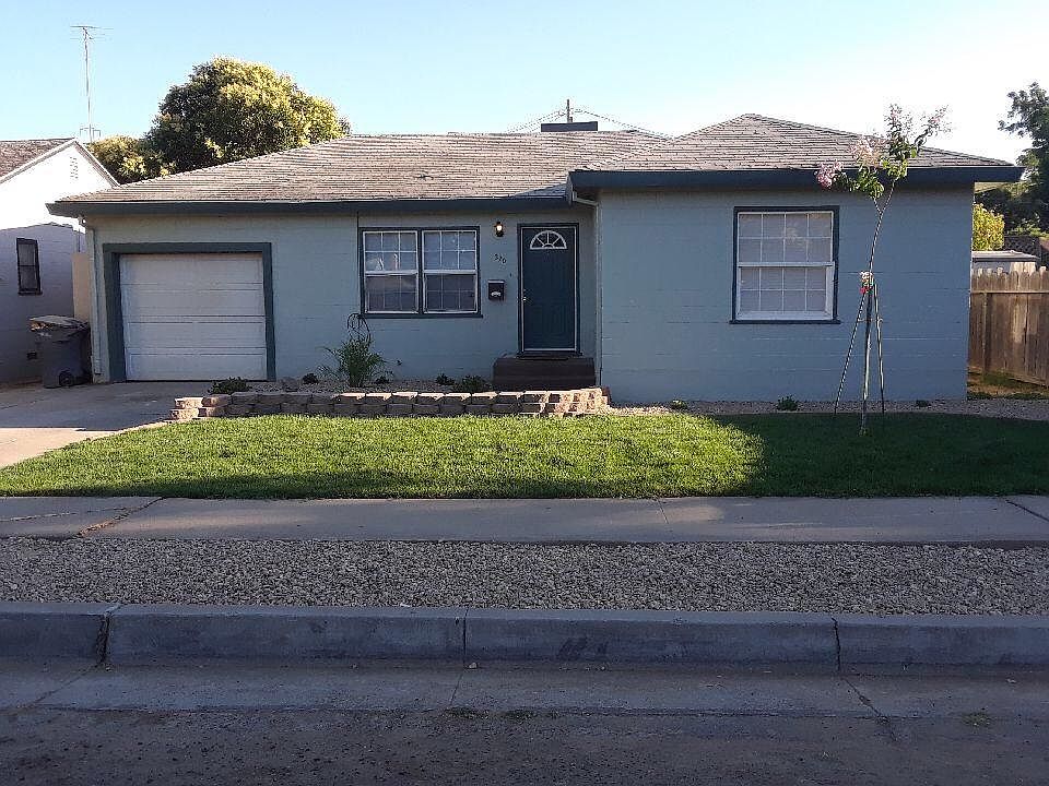 Front view. Newly landscaped yard with sprinklers and drip 
