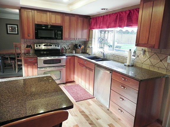 Keep an eye on backyard activities through the oversized kitchen window.