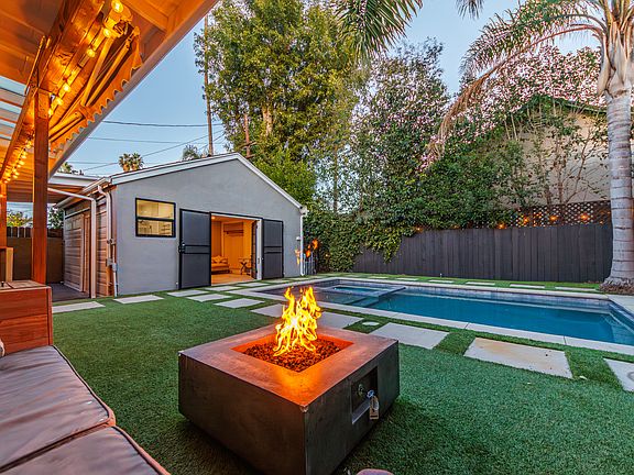 Backyard with pool, fire pit, and studio at the rear