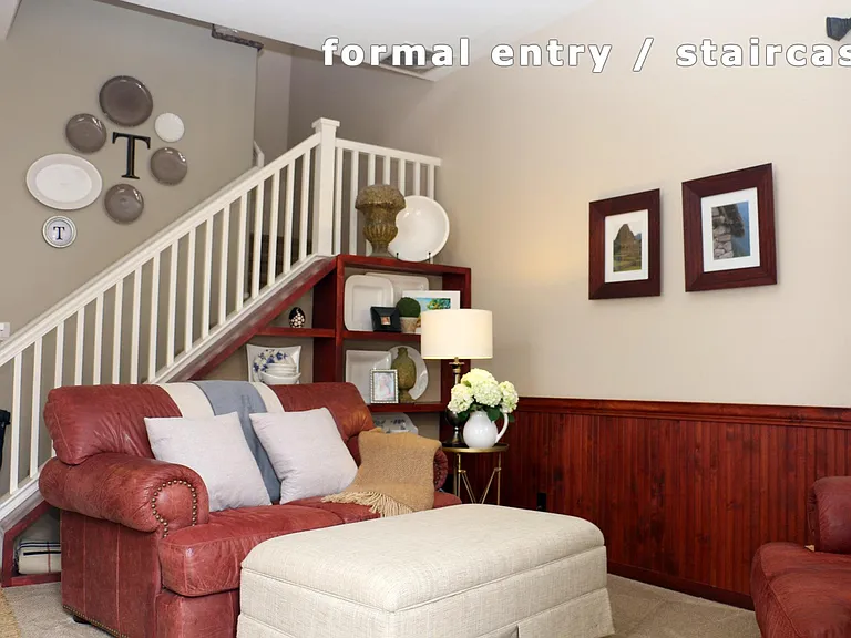 Formal Entry with custom wainscoting on the walls and custom book shelves with linen lined backings