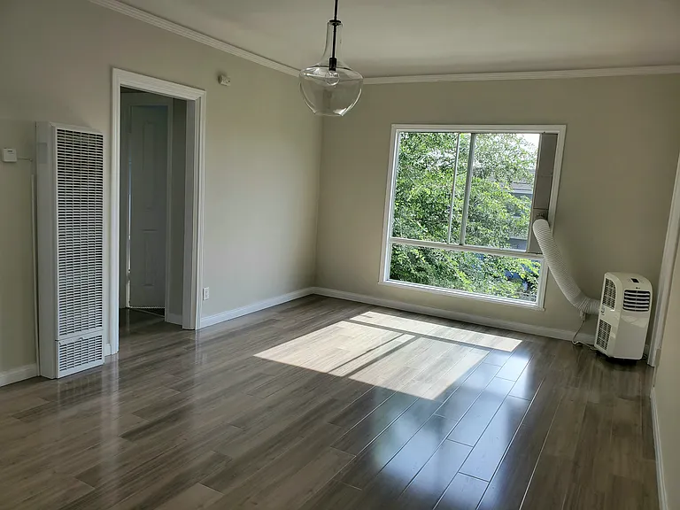 Well lit living room with view of trees