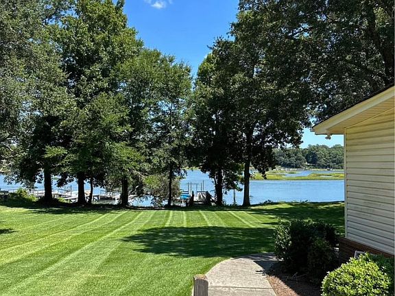 Water view from driveway and outside concrete parking