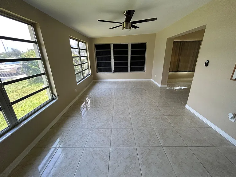 Living Room # 2 - measurements are ~ 10' wide x 18' deep (dark window is covered on outside by the hurricane shutters, which can be removed).