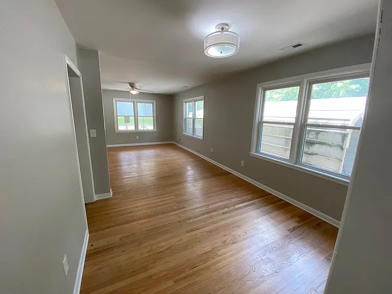 SPACIOUS open floor plan for living/dining room with GORGEOUS refinished 1940's hardwood floors.