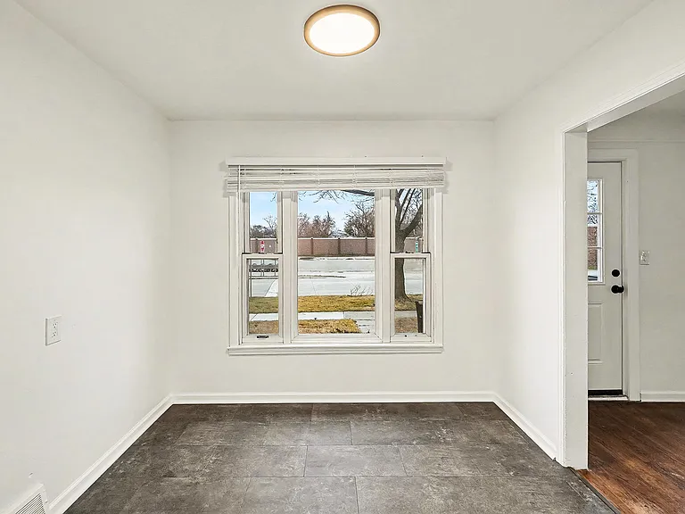 Dining area has great window with new blind and new flooring.