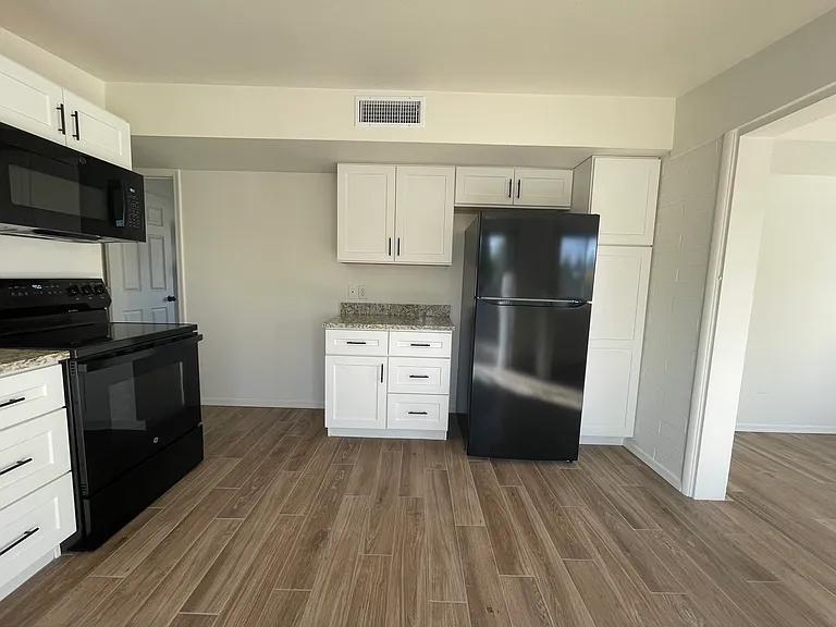 Kitchen w/ granite countertops, new cabinets, and appliances.