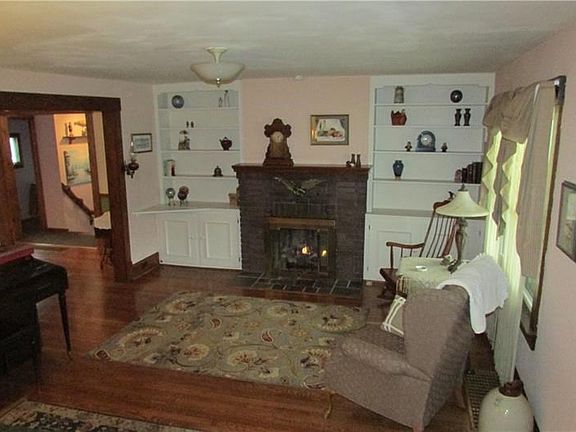 Living room with gas remote fireplace. Builtin cupboards.