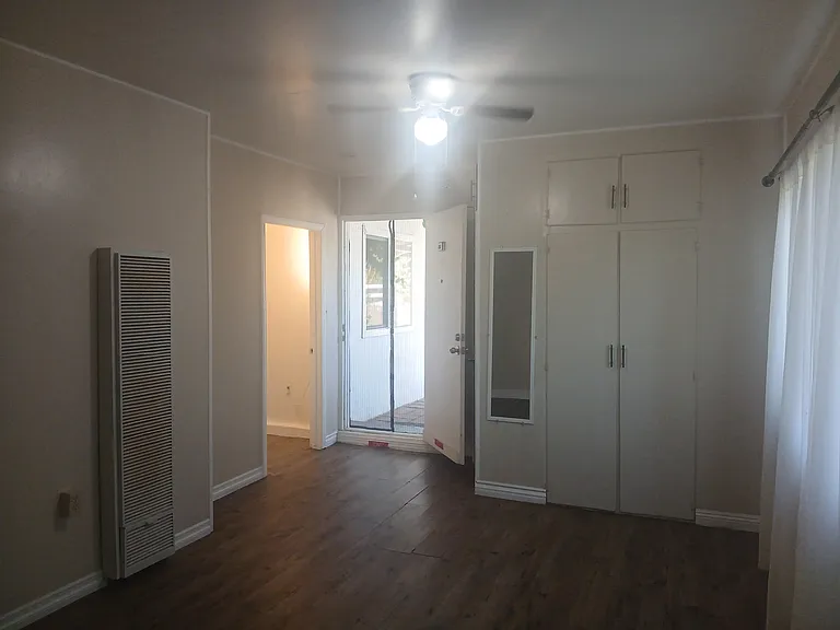 Bedroom / living room with front door to the apartment