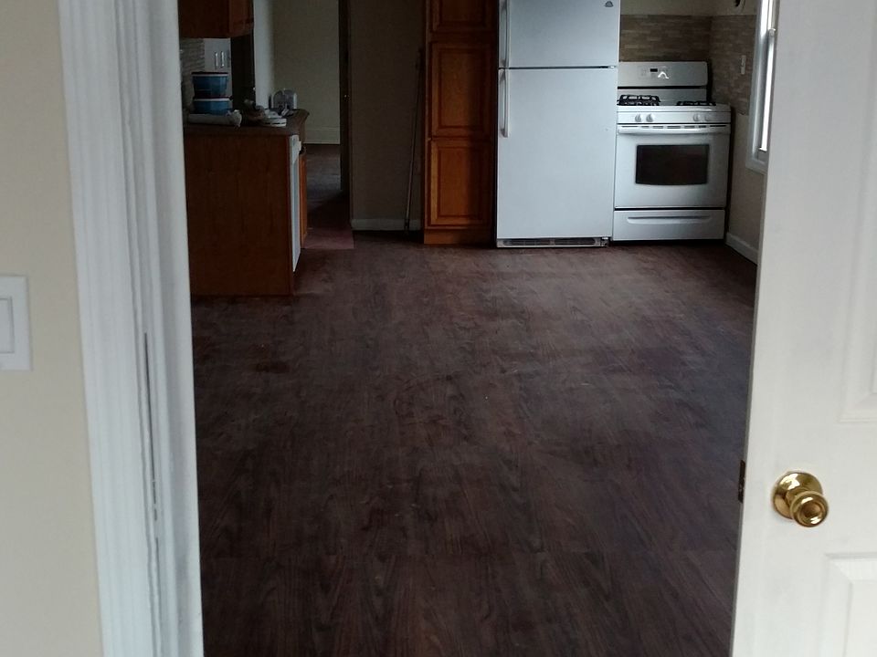view from bedroom into living room and kitchen
