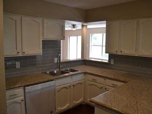 Kitchen with new granite countertops, backsplash and fixtures