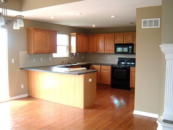 Kitchen features many cabinets, pantry, and adjoining laundry room!