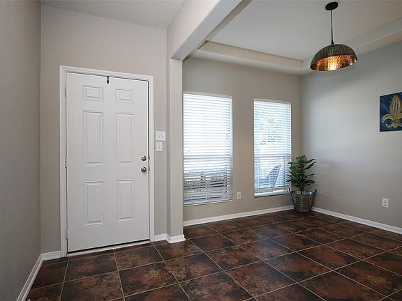 View of the front door and the dining room.