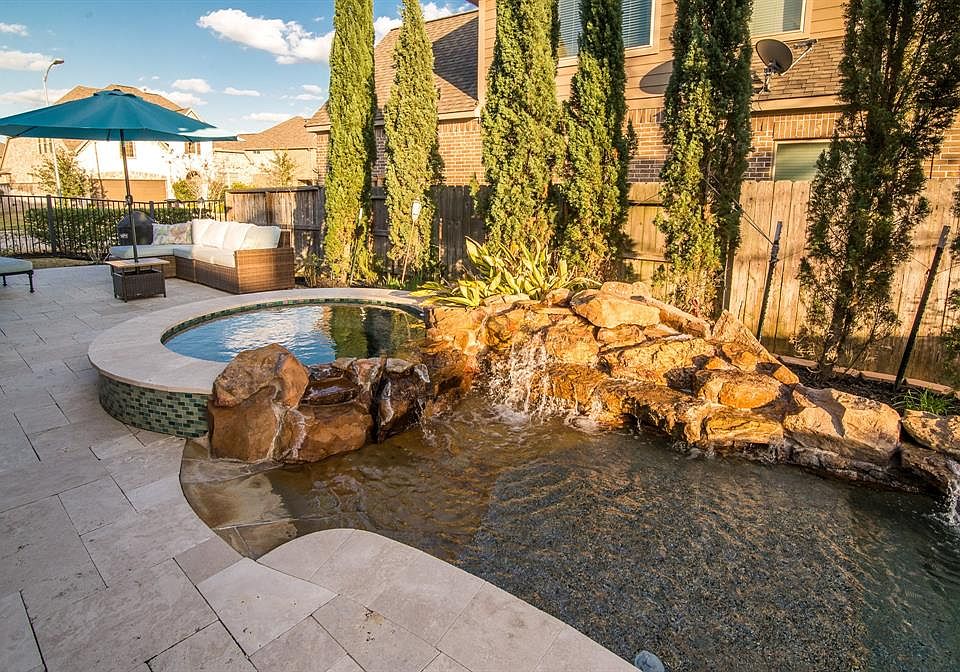 Welcome home to your Backyard Paradise, with a saltwater pool that has a Weeping Waterfall and Spa.