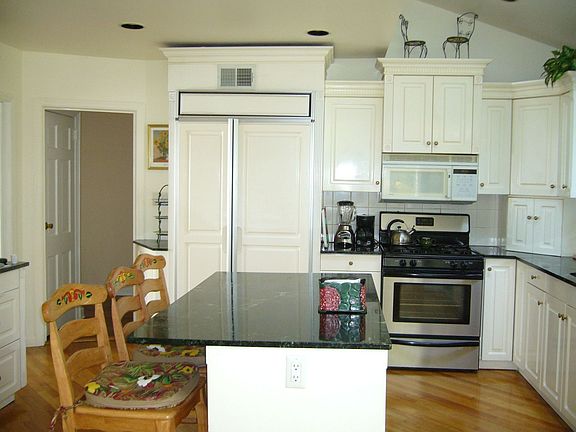wood cabinets,marble countertops, wood floor