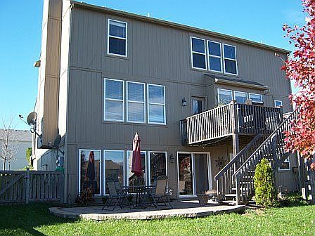 Back has patio, fence, and deck