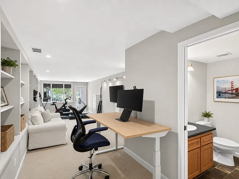 Multi-use room with private half bath and separate exterior access. Location: downstairs