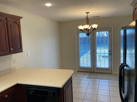 Eat-in kitchen features a place for two counter stools and a kitchen table. Lots of natural light. French doors walk out to patio and backyard.