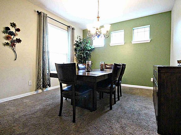 Here is the formal dining room with charming windows and light fixture.