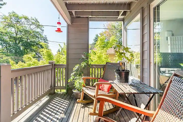 Front porch with rocking chairs and hummingbird feeder