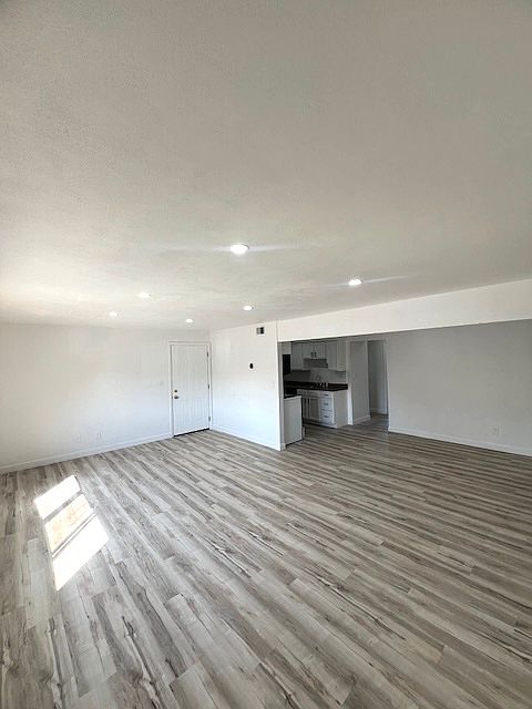 View from Living room to Kitchen and Dining room...Luxurious vinyl plank flooring...