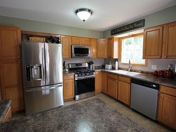 Immaculate updated kitchen with newer stainless steel appliances.