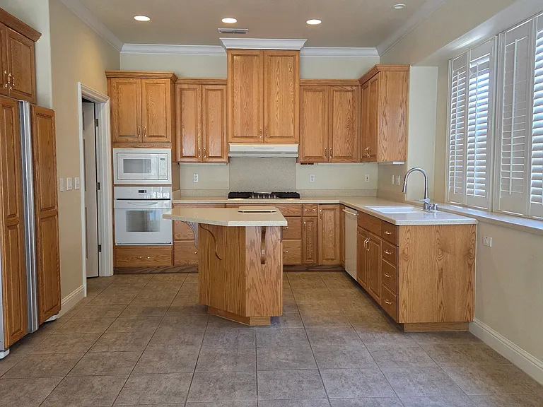 Large kitchen, new gas stovetop, electric oven, dishwasher, microwave and lots of storage