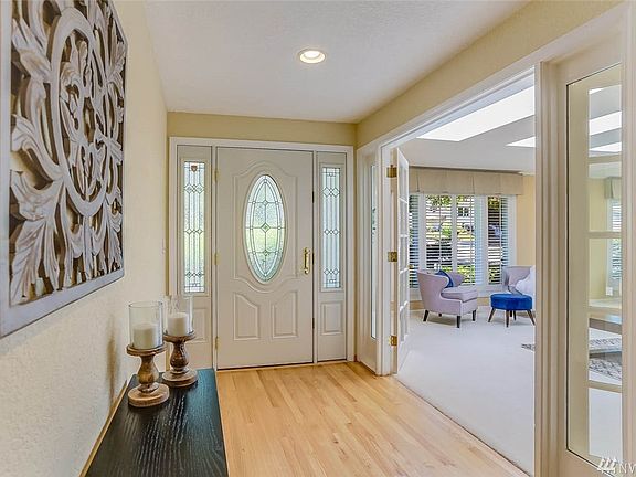 View of the front entry opening to the living room. On the main floor you will also find 3 additional guest bedrooms and a guest