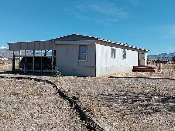 Back of home with smaller porch